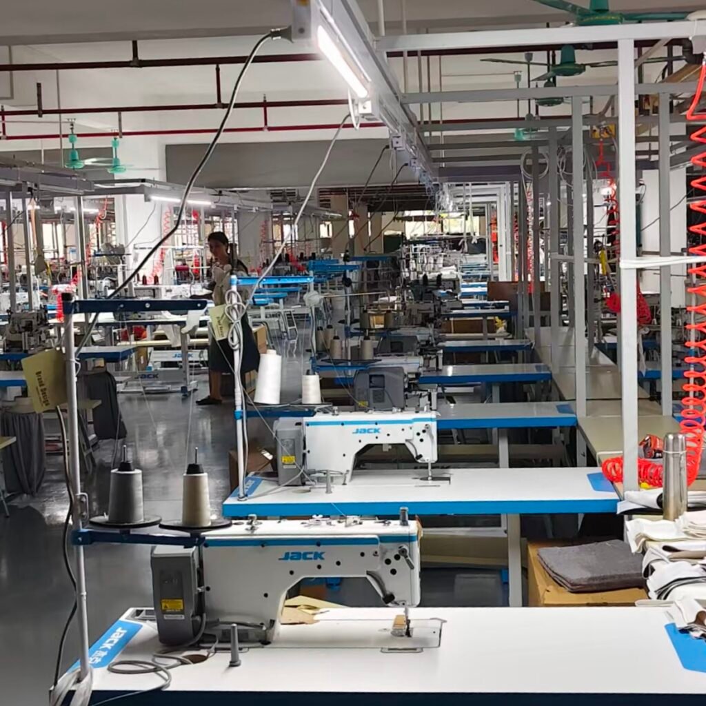 Garment sewing workshop with industrial sewing machines and production workstations