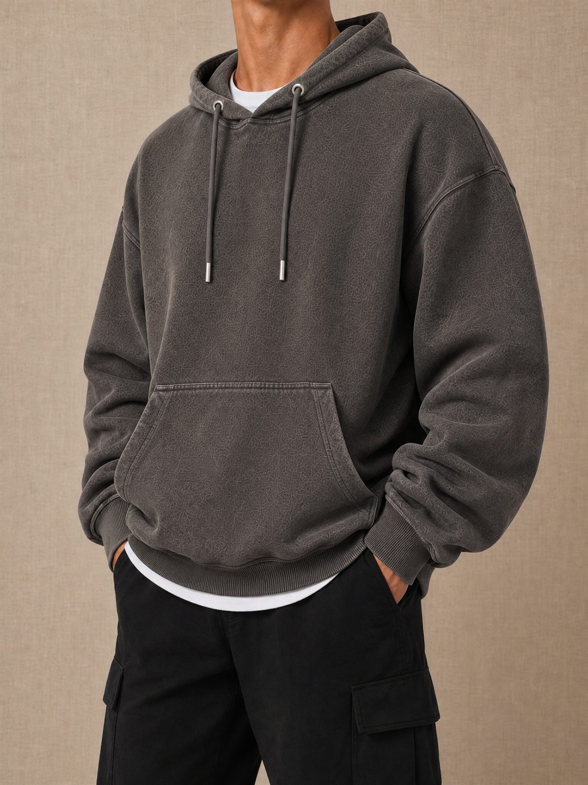 Charcoal pullover hoodie with drawcords and a front pouch, shown on a model