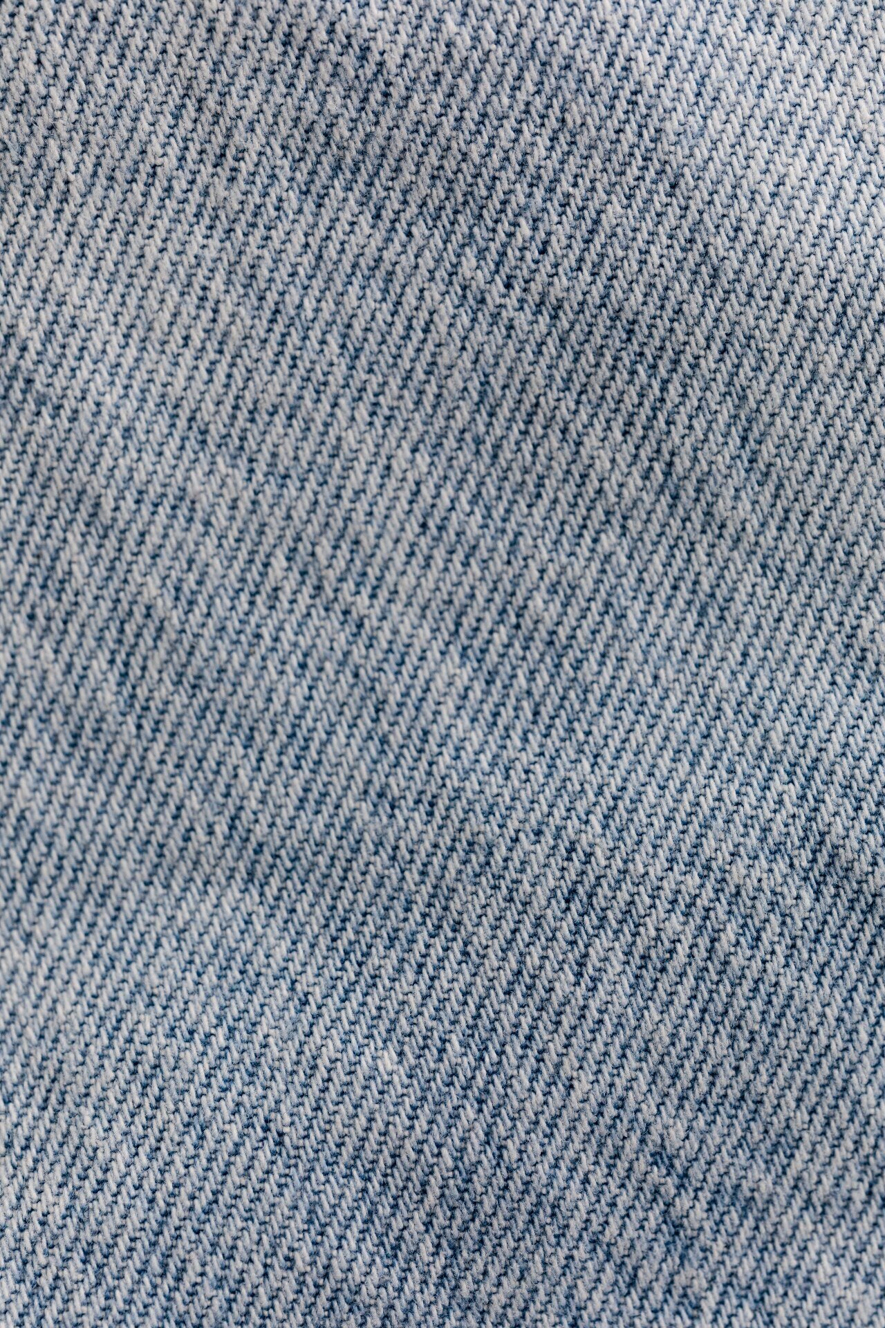 Macro close-up of blue denim twill weave fabric texture