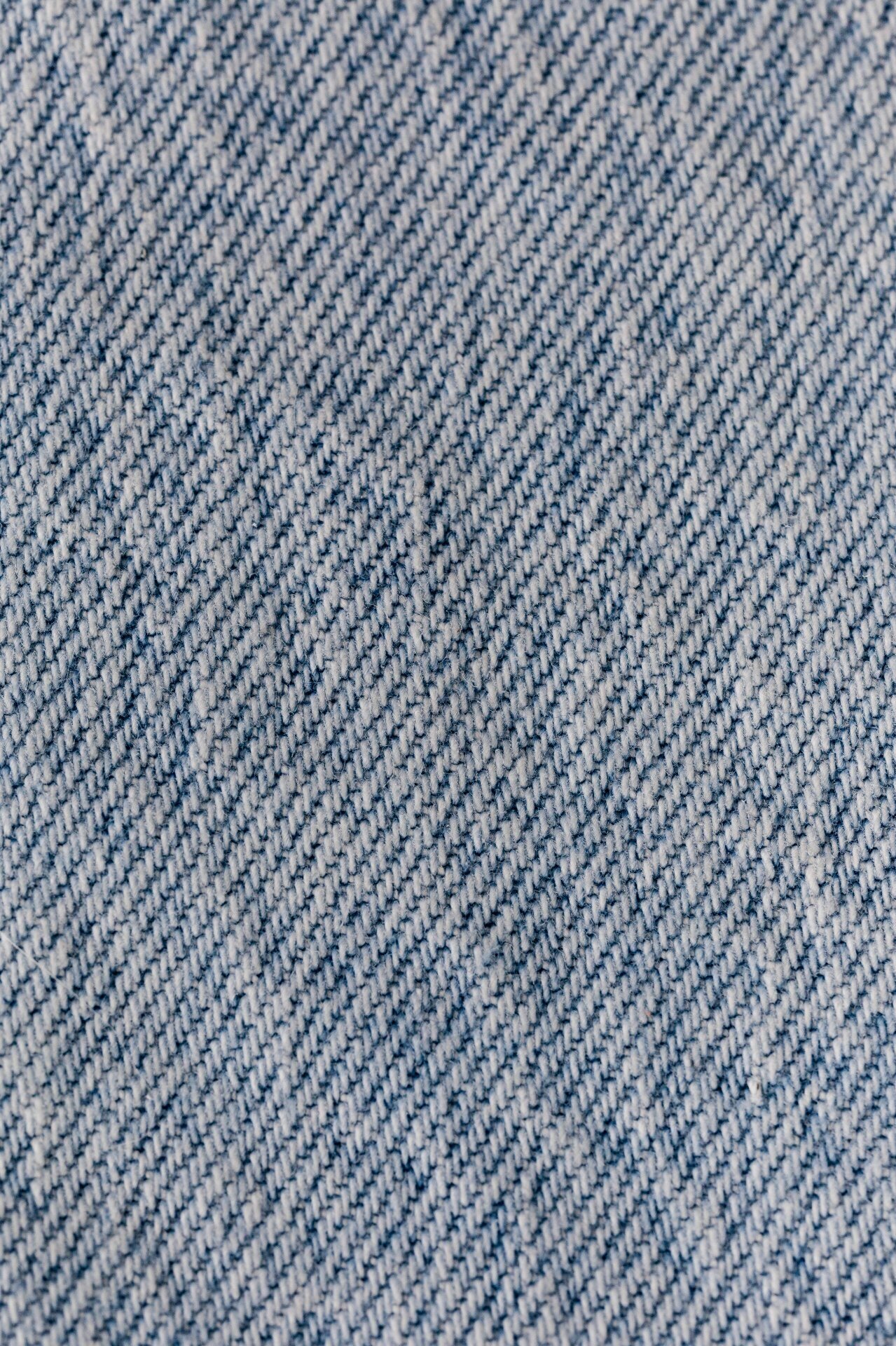 Diagonal denim twill weave texture detail in blue