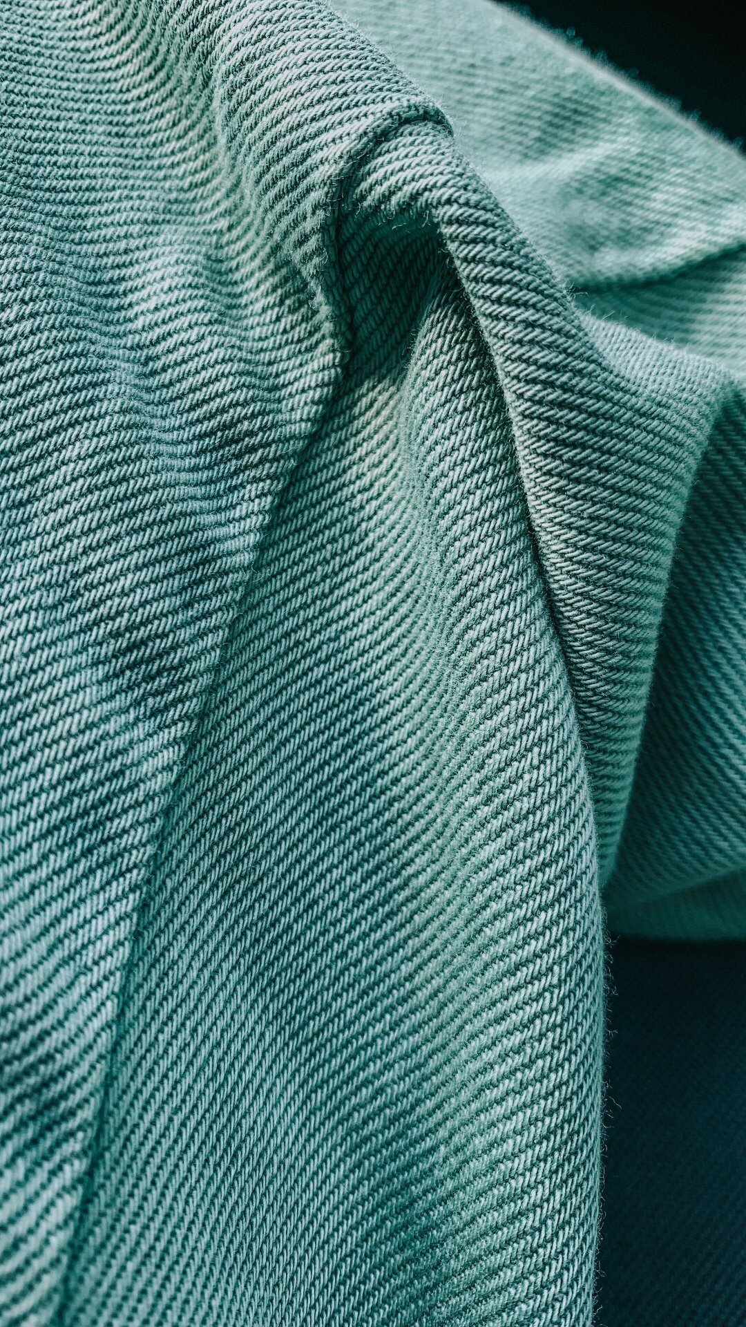 Teal green denim fabric drape, colour range sample