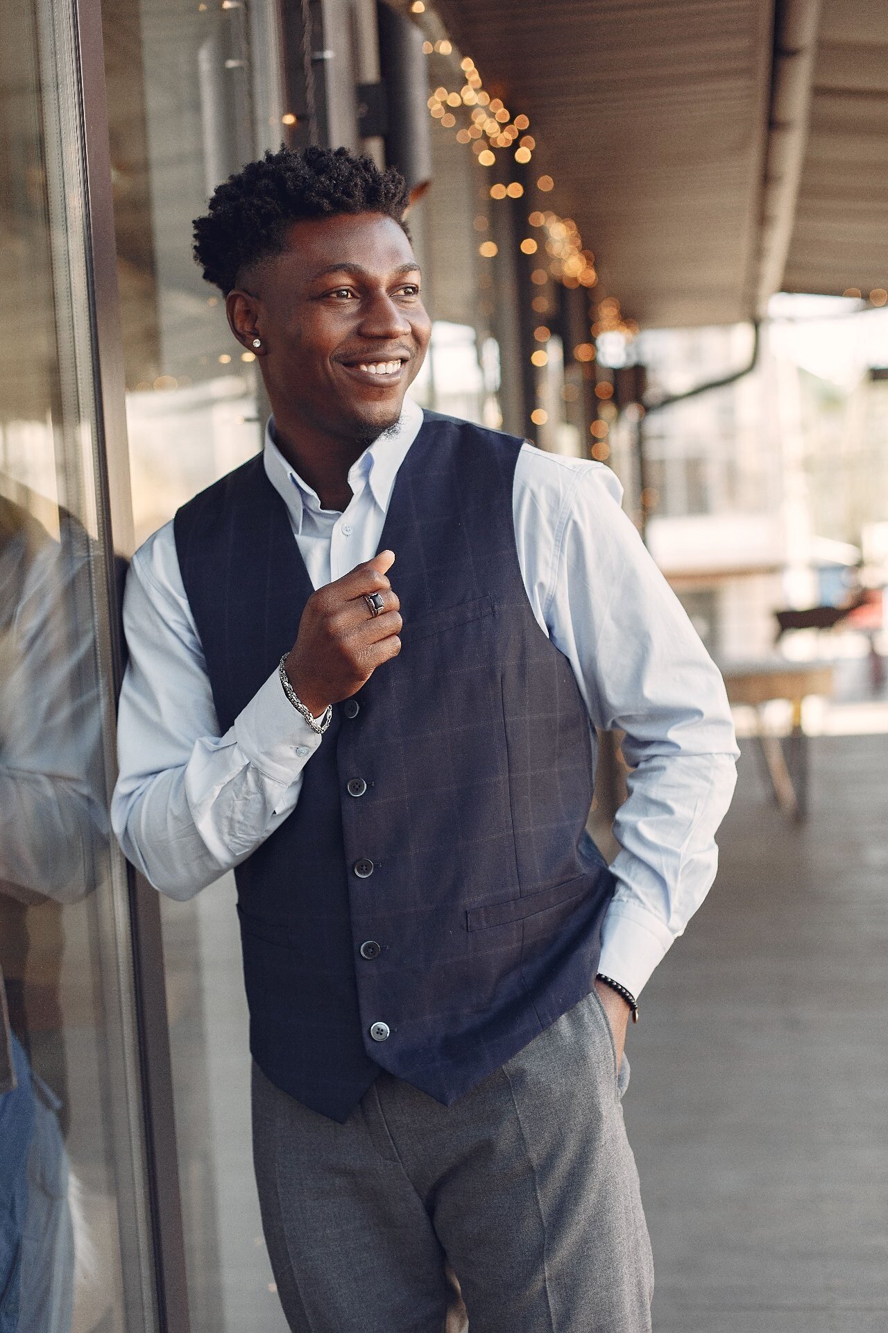 Men's navy checked waistcoat worn over a light blue shirt, smart casual menswear