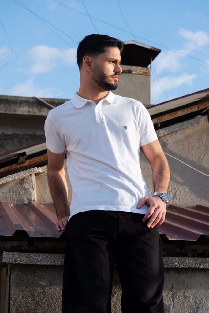 Men's white pique polo shirt with chest badge, custom polo shirt manufacturing sample