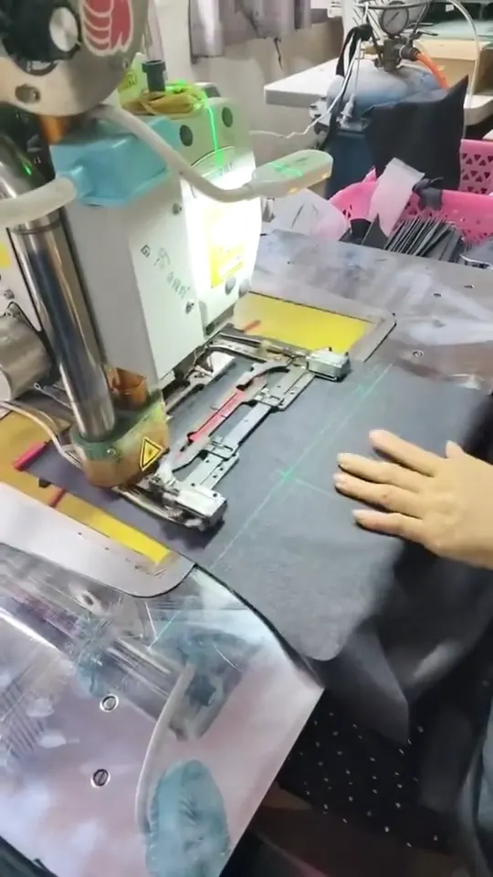 Hands positioning a dark fabric panel beneath a sewing template